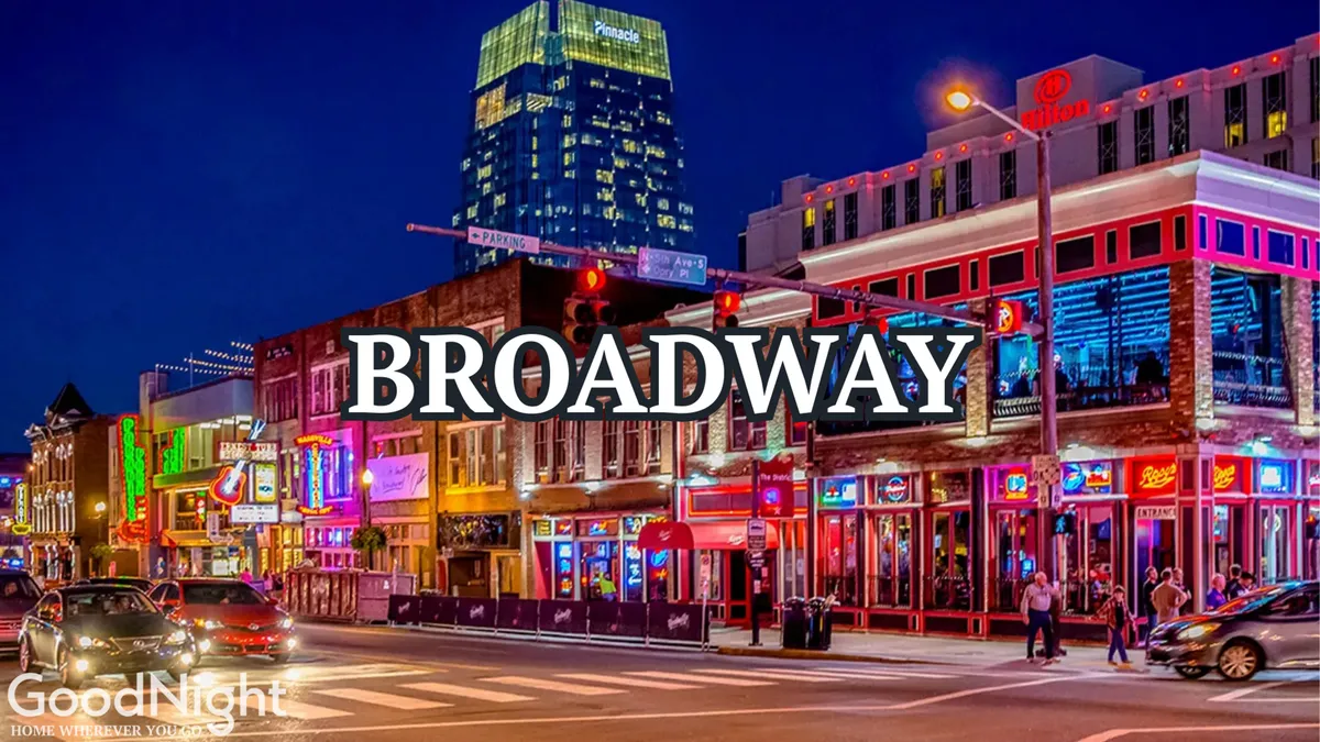A bustling Nashville street scene at night, filled with glowing neon lights, historic buildings, and lively crowds. The energy of the city’s nightlife is palpable, capturing the excitement of Broadway and Nashville’s famed music scene.